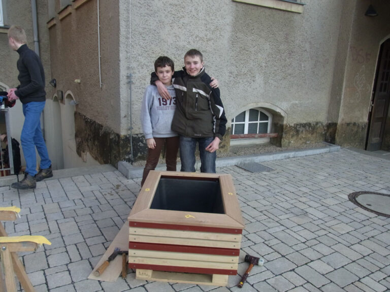 Schüler und Eltern bauen Pflanzkübel für den Schulhof